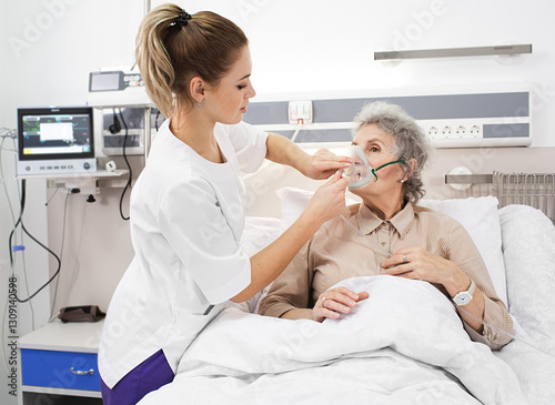 Photography Healthcare worker supporting an elderly patient by fitting a breathing mask for