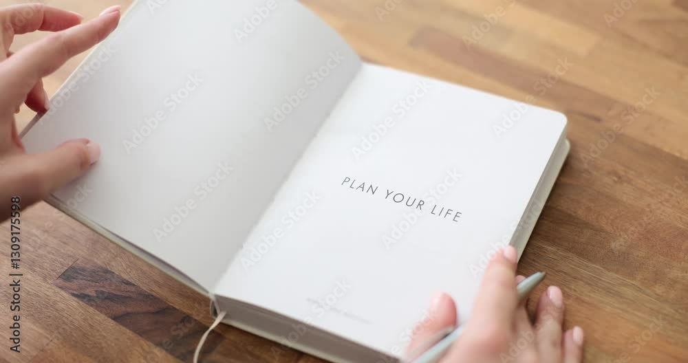 An image of hands turning a life planning journal page, inspiring personal development and organization. An image of hands turning a life planning journal page, inspiring personal development and organization.