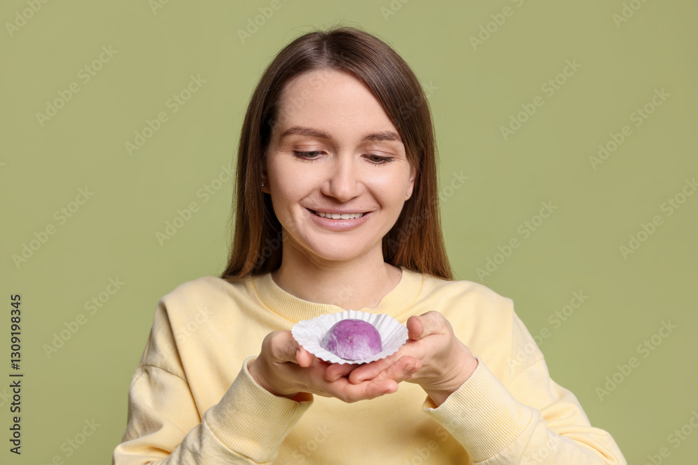 Woman with tasty mochi on olive background Woman with tasty mochi on olive background