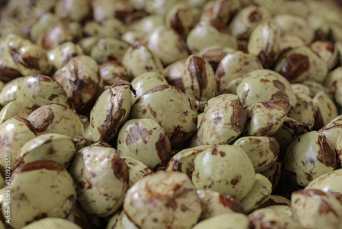 Photo of a pile of yellowish jengkol or archidendron pauciflorum skin taken from a high angle from close range photo