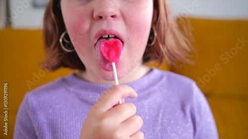 Sweet moments of joy with a heart shaped lollipop in a cozy living room