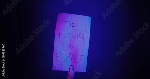 Woman holding a banner that says the futre is female