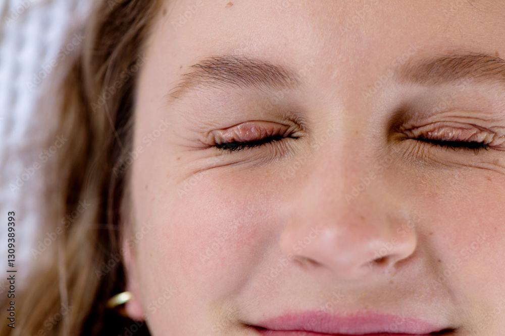 close up of woman with eyes squeezed shut close up of woman with eyes squeezed shut