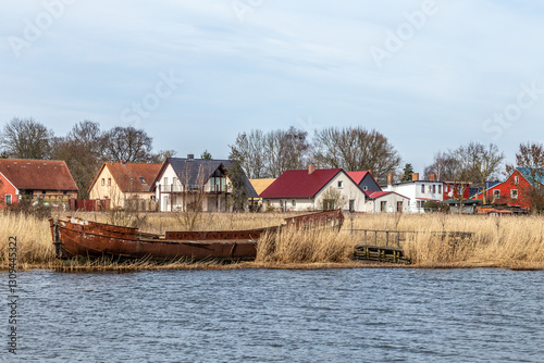 harbor of Usedom at the island with old boats and houses behind the reed grass dune photo