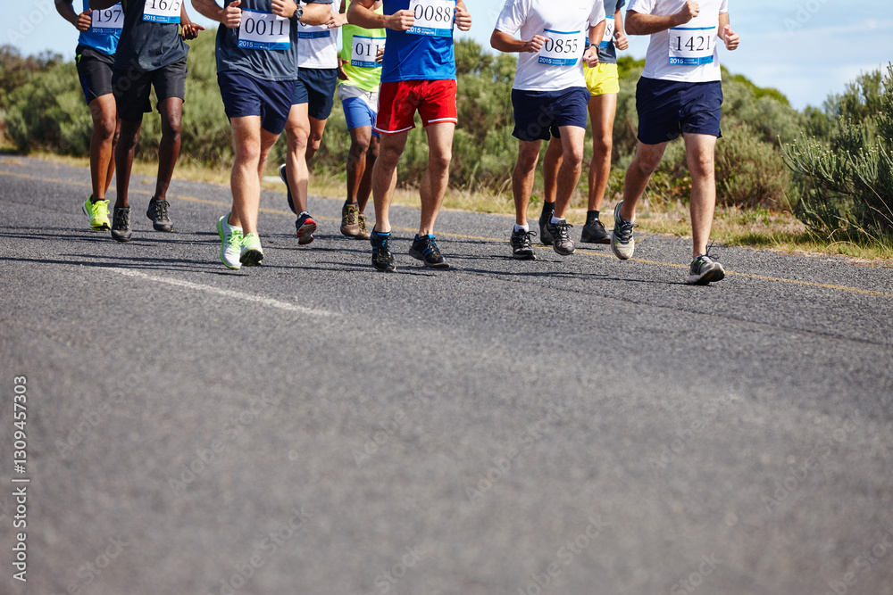 Marathon, legs and group running in road for competition, healthy body or cardio exercise. Low angle, race and athletes with fitness performance, sports contest or workout pace for endurance training Marathon, legs and group running in road for competition, healthy body or cardio exercise. Low angle, race and athletes with fitness performance, sports contest or workout pace for endurance training