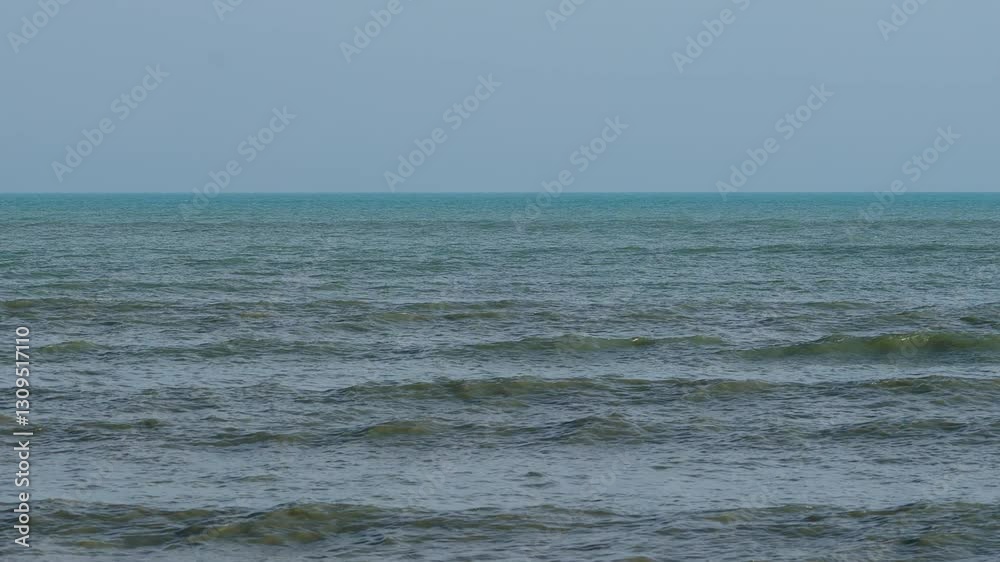Waves moving across the surface of the Andaman Sea during windy sunny weather with clear blue sky in the background Waves moving across the surface of the Andaman Sea during windy sunny weather with clear blue sky in the background