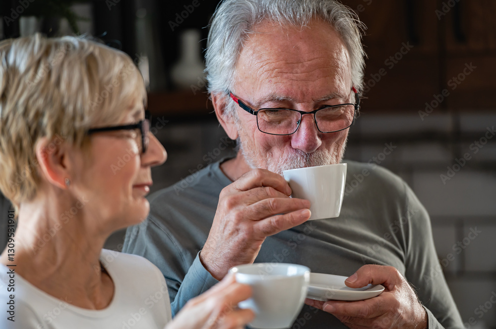 A happy senior couple enjoys a morning coffee together in their cozy kitchen, sharing a warm conversation and cherishing the present moments with love and affection. A happy senior couple enjoys a morning coffee together in their cozy kitchen, sharing a warm conversation and cherishing the present moments with love and affection.