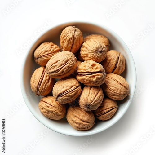 Top view of walnuts in white bowl isolated on white background. Healthy snack ingredient, delicious vegan food. Brown kernel heap, natural tasty nuts, organic fruit seed.