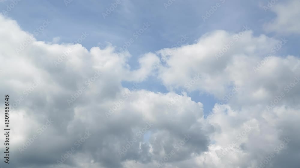 Overcast cloudscape time lapse with fast moving white clouds drift across an overcast sky, capturing the beauty of nature and changing weather patterns timelapse