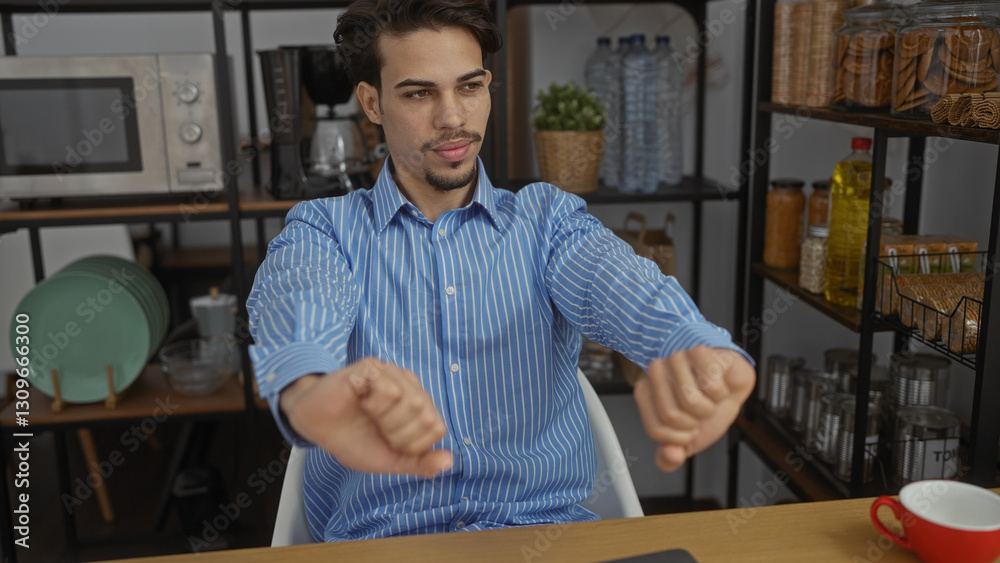 Fototapeta premium Young hispanic man stretches in an office with shelves filled with jars and dishes, suggesting a relaxed and friendly work environment.