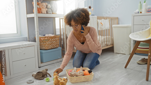 Woman organizing toys on floor while talking on phone in baby room with cradle and baskets around the interior space. photo