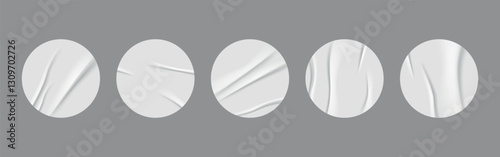 Vector realistic 3D illustration of white round stickers on a grey background. Set of white round crumpled sticker mockups. Adhesive paper labels with a wrinkled effect. Blank templates for price tags