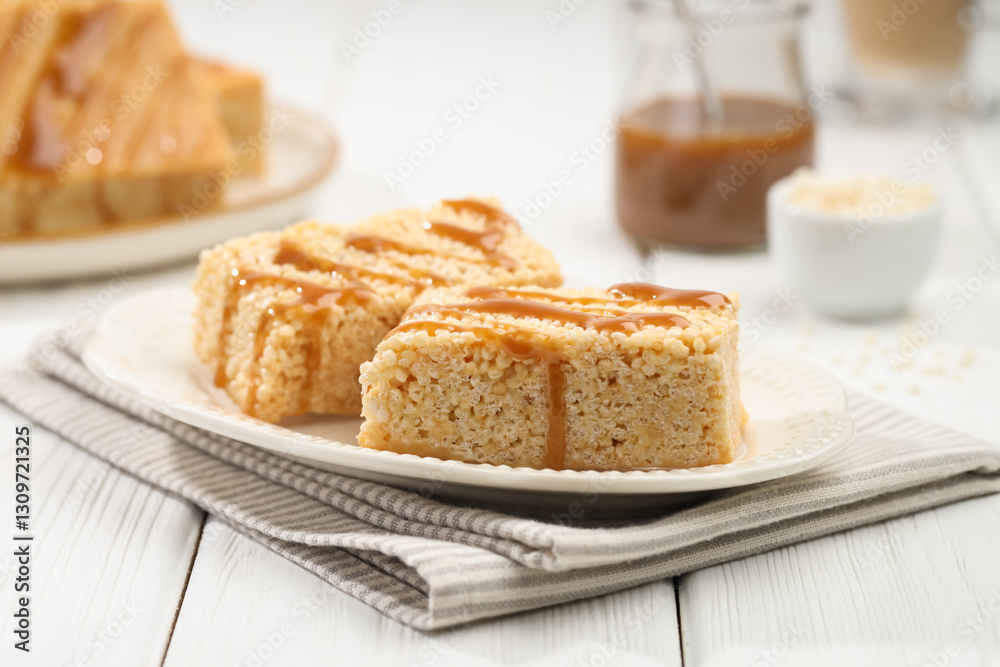 Delicious caramel puffed rice bars on white wooden table, closeup Delicious caramel puffed rice bars on white wooden table, closeup