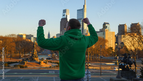 Man doing the Rocky pose on the steps of Philadelphia, PA USA