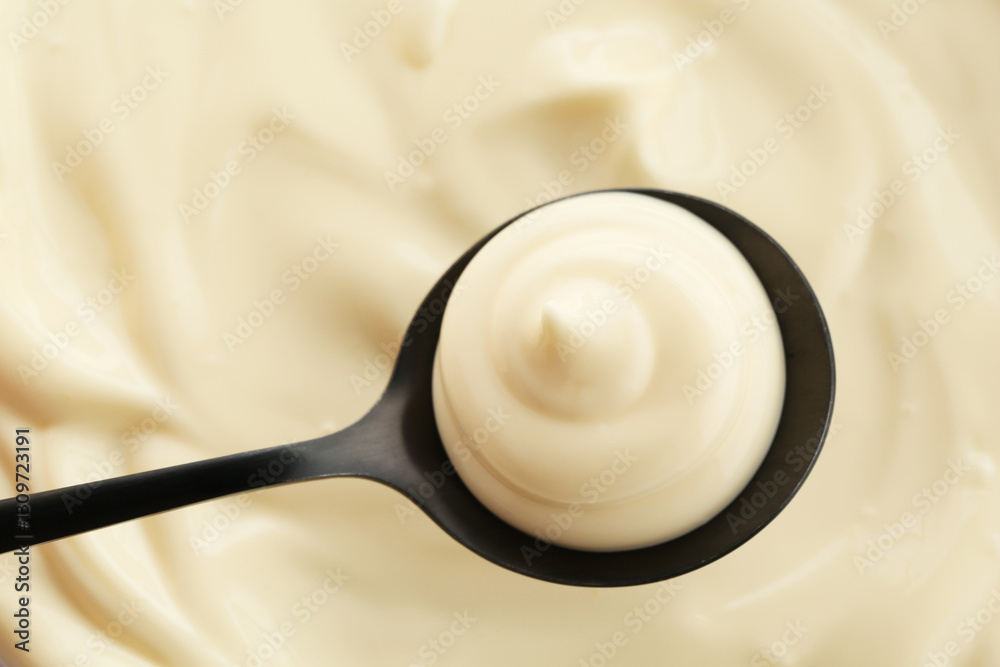 Spoon with delicious mayonnaise sauce, top view Spoon with delicious mayonnaise sauce, top view