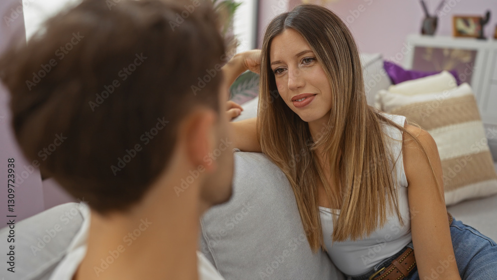 Woman and man in cozy living room engaging in intimate conversation suggesting relationship and connection within modern home interior.
