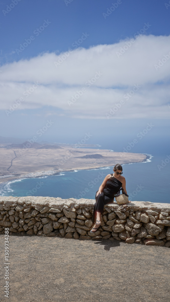 Young woman sightseeing outdoors in lanzarote canary islands with a stunning ocean view and clear sky Young woman sightseeing outdoors in lanzarote canary islands with a stunning ocean view and clear sky