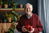 Portrait of a cheerful caucasian elderly man in his 90s holding a gift in front of modern minimalist interior