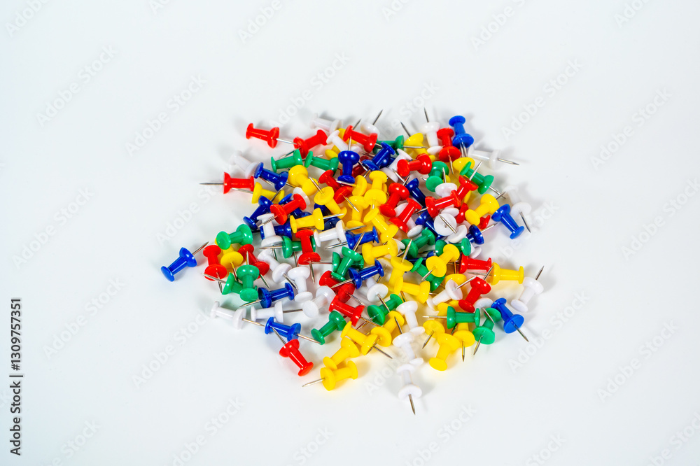 A pile of colorful push pins on a white background A pile of colorful push pins on a white background