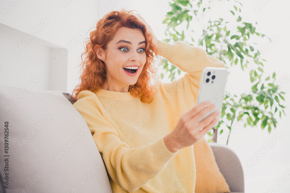 Photo of adorable impressed lady wear yellow sweatshirt enjoy online shopping modern gadget indoors room home house Photo of adorable impressed lady wear yellow sweatshirt enjoy online shopping modern gadget indoors room home house