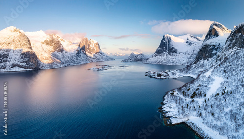 Wallpaper Mural Arctic Majesty: Breathtaking panoramic view of a snow-capped mountain range reflecting in the tranquil blue waters, capturing the serenity of the arctic landscape under a clear sky. Torontodigital.ca