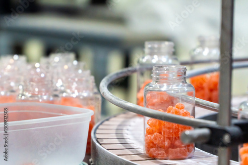 Nutritional supplement jars on the packaging process on a confectionery factory facility