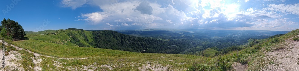 Panoramic view of the green hills and the forest Panoramic view of the green hills and the forest