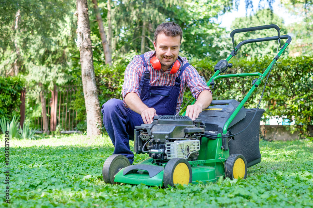 Fototapeta premium Man portrait mowing the lawn with lawnmower