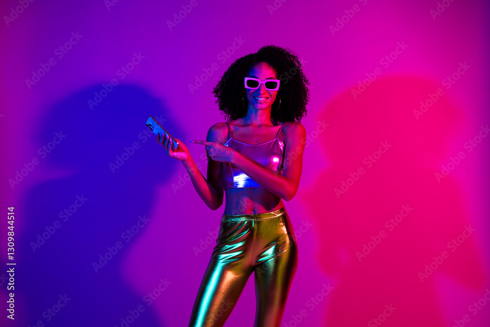 Stylish woman illuminated by neon lights in vibrant club atmosphere, wearing retro-inspired outfit and glowing with joyful confidence. Stylish woman illuminated by neon lights in vibrant club atmosphere, wearing retro-inspired outfit and glowing with joyful confidence.