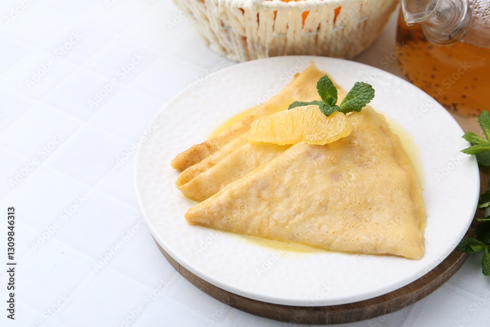 Tasty crepes Suzette on white tiled table, closeup. Space for text Tasty crepes Suzette on white tiled table, closeup. Space for text