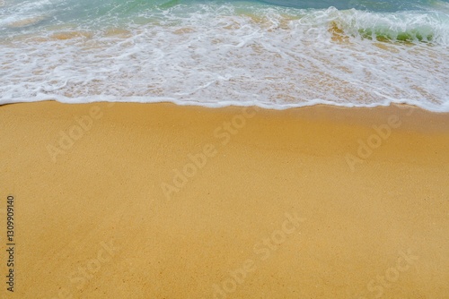 Fototapeta Naklejka Na Ścianę i Meble -  The calming sight of the beach offers a perfect backdrop for relaxation and tranquility. With soft, golden sand underfoot and gentle waves lapping at the shore, it creates an idyllic atmosphere.