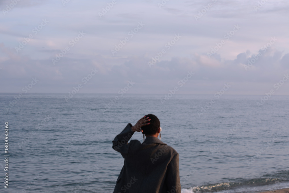 Portrait of young woman with short hair cut looking away posing outdoor. Portrait of young woman with short hair cut looking away posing outdoor.