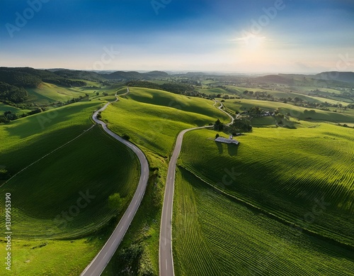 A high-angle view of a tranquil countryside with winding roads and green fields