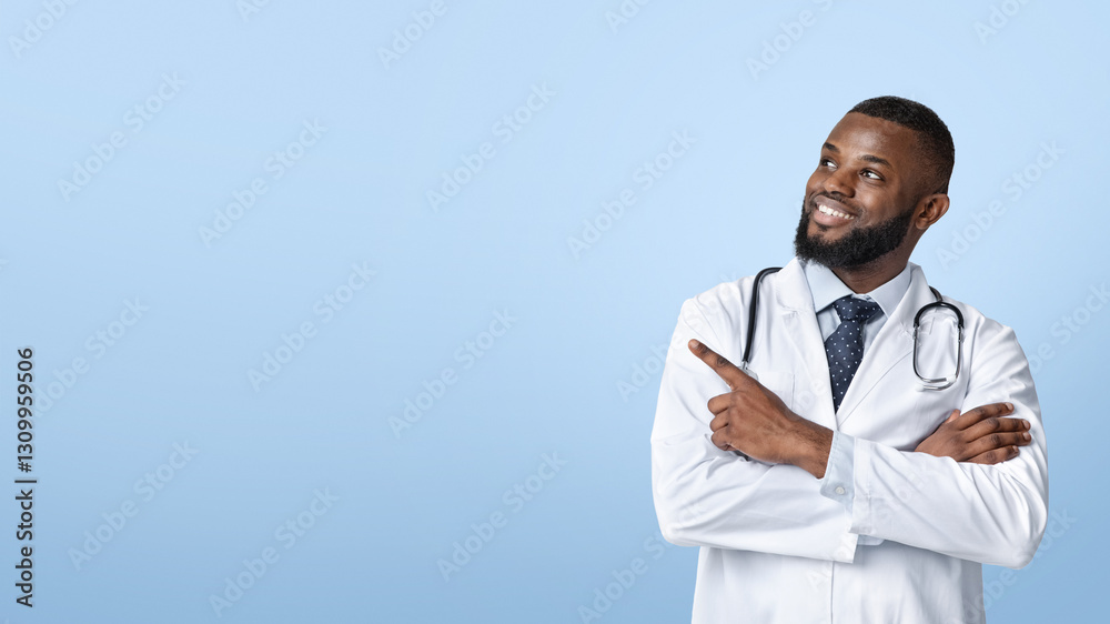 Note it, space for advertisement. Positive african doc with arms crossed pointing at copy space, white background, panorama Note it, space for advertisement. Positive african doc with arms crossed pointing at copy space, white background, panorama