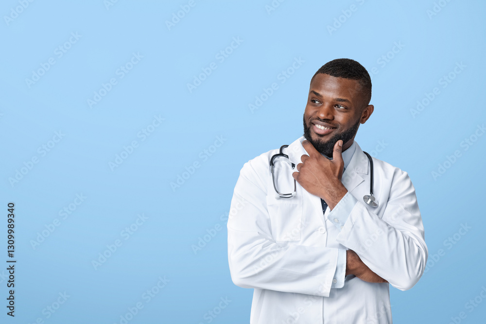 Interested african american doctor in white uniform looking at copy space, white studio background Interested african american doctor in white uniform looking at copy space, white studio background