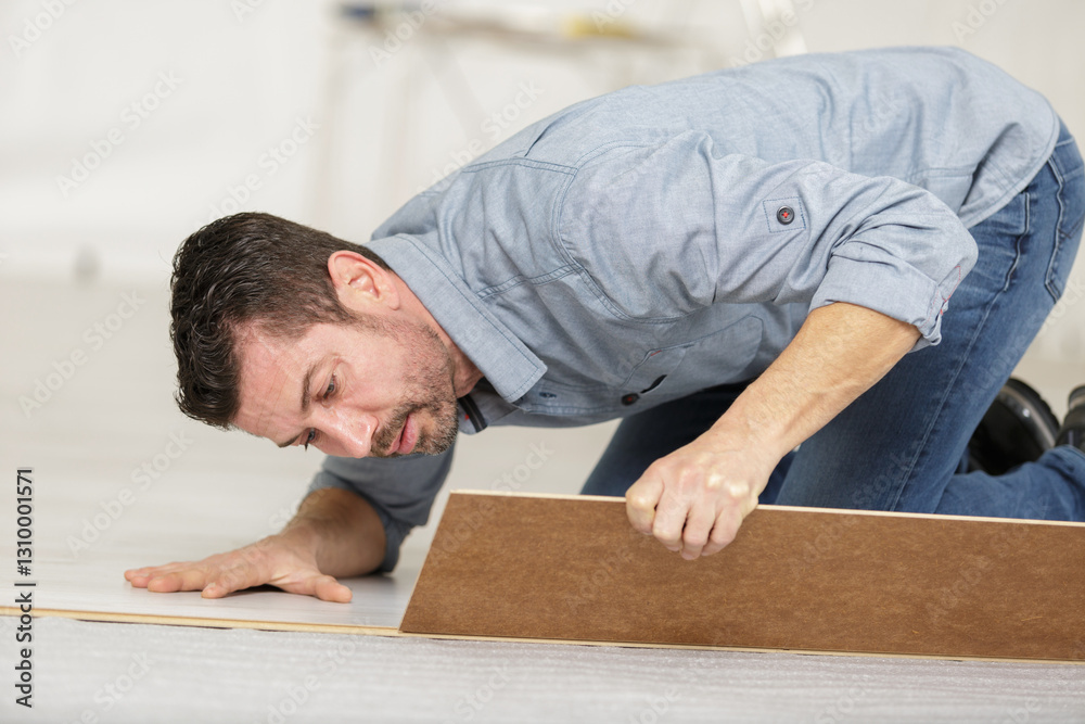 man installing new laminated wooden floor close up man installing new laminated wooden floor close up