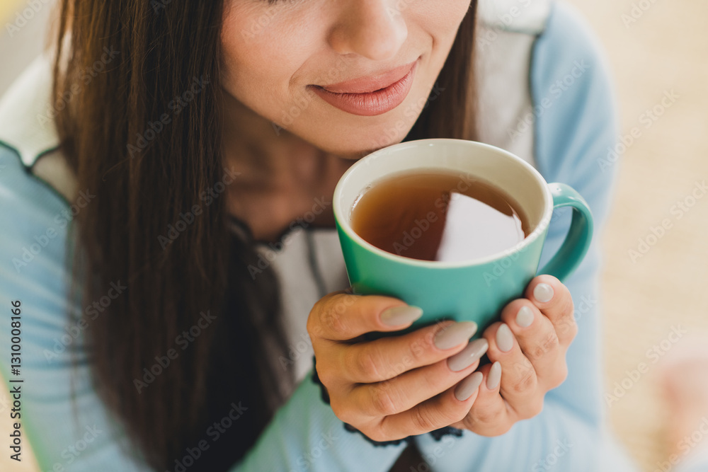 Young woman enjoying a warm beverage in a cozy home environment, highlighting relaxation, comfort, and casual lifestyle. Young woman enjoying a warm beverage in a cozy home environment, highlighting relaxation, comfort, and casual lifestyle.