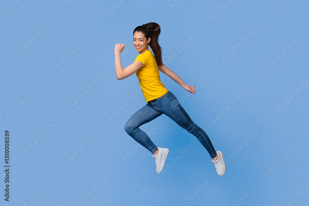 Time To Move. In Motion Portrait Of Happy Asian Girl Jumping In The Air Over Purple Background, Full-Length Shot With Copy Space Time To Move. In Motion Portrait Of Happy Asian Girl Jumping In The Air Over Purple Background, Full-Length Shot With Copy Space