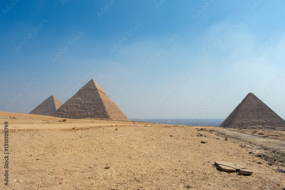 View of The Giza Necropolis, Famed archaeological site featuring the Great Pyramids, the Great Sphinx and The Great Pyramid of Giza in the desert of Giza, Cairo, Egypt. View of The Giza Necropolis, Famed archaeological site featuring the Great Pyramids, the Great Sphinx and The Great Pyramid of Giza in the desert of Giza, Cairo, Egypt.