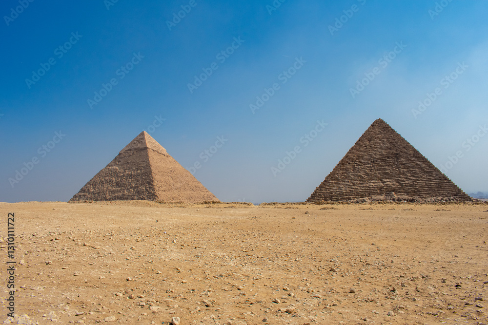 View of The Giza Necropolis, Famed archaeological site featuring the Great Pyramids, the Great Sphinx and The Great Pyramid of Giza in the desert of Giza, Cairo, Egypt. View of The Giza Necropolis, Famed archaeological site featuring the Great Pyramids, the Great Sphinx and The Great Pyramid of Giza in the desert of Giza, Cairo, Egypt.