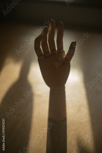 Wooden mannequin's hand in the dark	