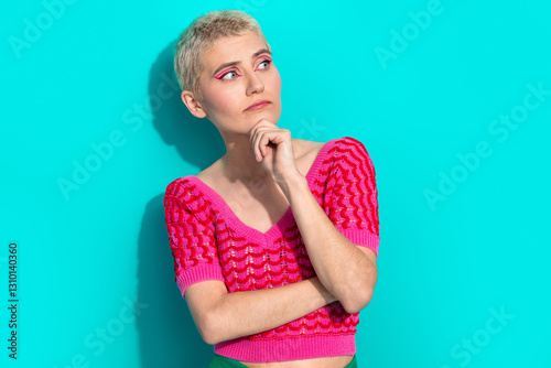 Young woman in a stylish pink top with vibrant turquoise background