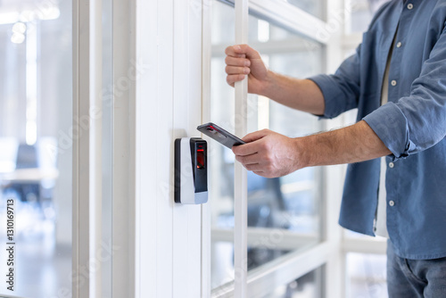 Man uses his smartphone to access a secure area, highlighting modern security technology and mobile access solutions.