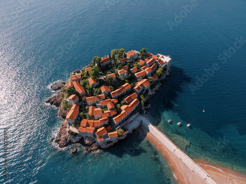 Tableau sur toile Small boats are moored at the isthmus to the island of Sveti Stefan