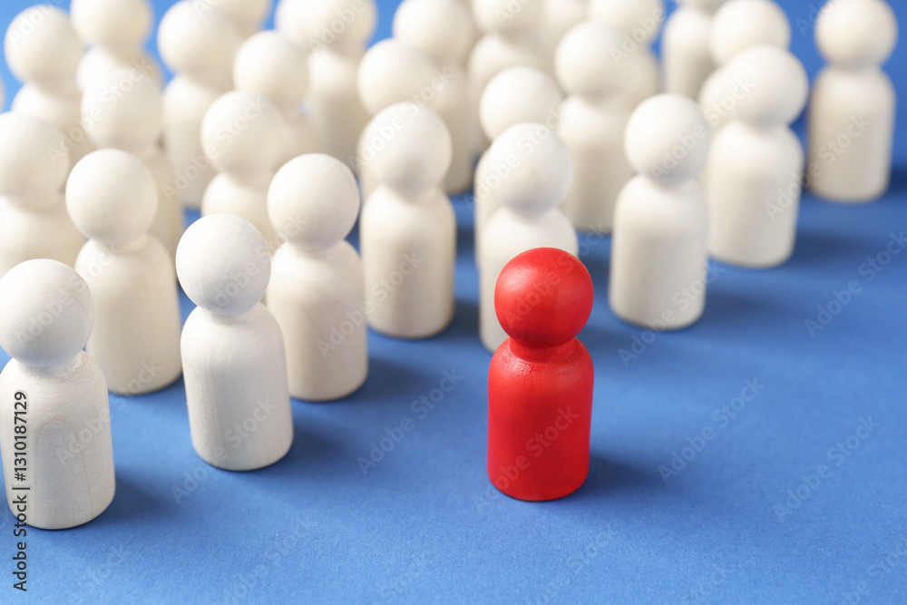 Competition concept. Red human figure ahead of other ones on blue background, closeup Competition concept. Red human figure ahead of other ones on blue background, closeup