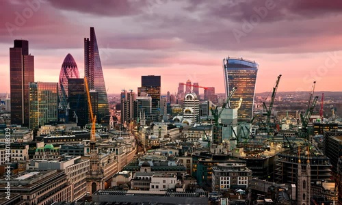 City of London at sunset, beautiful aerial view of modern skyscrapers and office buildings with night lights in windows 