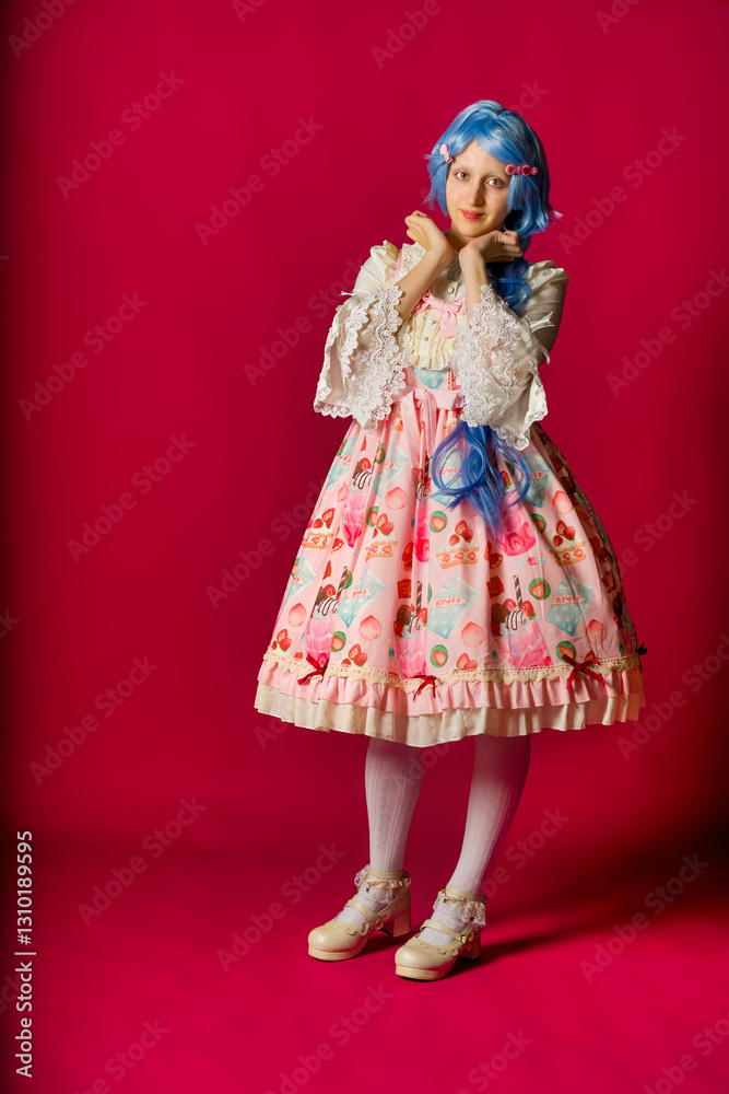 Cosplayer wearing colorful lolita dress posing on pink background Cosplayer wearing colorful lolita dress posing on pink background