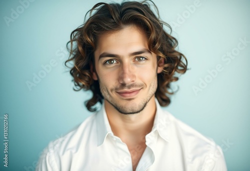A serene portrait of a man with long hair and a warm smile photo