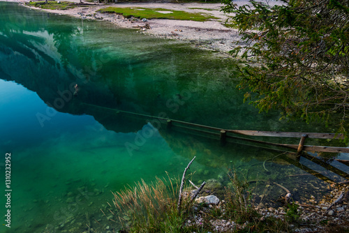 Obraz na płótnie lago di braies, pragser Wildsee lake, at the morning in summer stones with a fence in the water w salonie