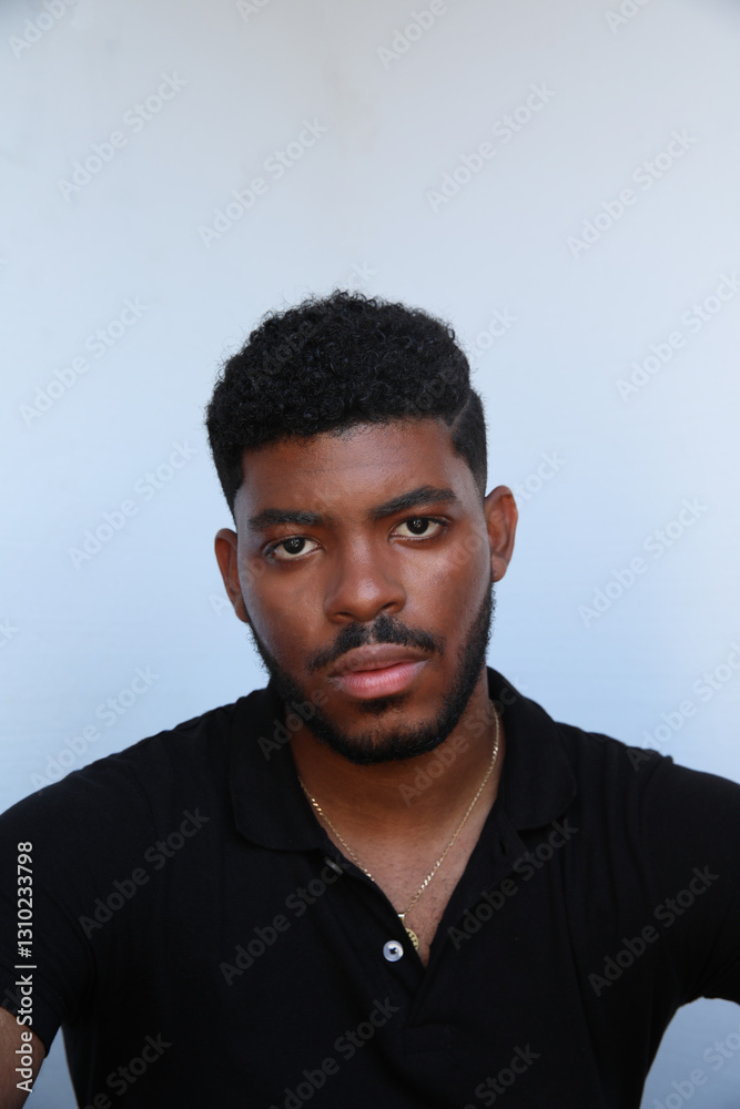 Obraz premium Vertical headshot of African American man over isolated white background looking at the camera. Isolated.